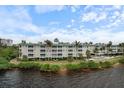 Waterfront condo building with lush landscaping and private access to the water at 5116 Melbourne St # B303, Punta Gorda, FL 33980