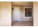 Front door entrance with white door and window at 1349 Aqui Esta Dr # 125, Punta Gorda, FL 33950