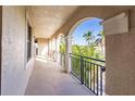 Covered walkway with arched openings and tropical views at 1349 Aqui Esta Dr # 125, Punta Gorda, FL 33950