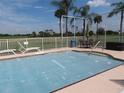 Community pool area with patio furniture and golf course views at 1360 Rio De Janeiro Ave # 117, Punta Gorda, FL 33983