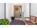 Inviting front entrance with a fall wreath and a welcoming bench at 12333 Willmington Blvd, Port Charlotte, FL 33981