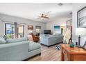 Spacious living room with light teal sofas and wood-look floors at 12333 Willmington Blvd, Port Charlotte, FL 33981