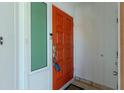 Front entrance with an ornate orange door and sidelight at 161 Carlisle Nw Ave, Port Charlotte, FL 33952