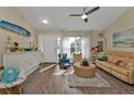 Bright living room with hardwood floors, comfy seating, and coastal decor at 17396 Cox Ave, Port Charlotte, FL 33948