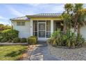 Front entrance with a screened porch and walkway at 17458 Fuego Ln, Punta Gorda, FL 33955