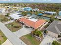 An aerial view of a waterfront home with a pool and boat dock at 1923 Pennsylvania Ave, Englewood, FL 34224