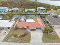 Aerial view showcasing a single-Gathering home, canal views, and lush landscaping at 1923 Pennsylvania Ave, Englewood, FL 34224