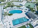 Aerial view of a community pool area with a large swimming pool, lounge chairs, and recreational facilities at 207 Blackburn Blvd, North Port, FL 34287