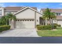 Exterior view of two-story villa with attached garage and landscaping at 3800 Bal Harbor Blvd # 312, Punta Gorda, FL 33950