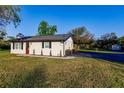 Updated home exterior with a newly paved driveway and landscaping at 1010 Robinhood Dr, Punta Gorda, FL 33982