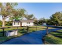 Charming home exterior with a long driveway and a rustic fence at 1010 Robinhood Dr, Punta Gorda, FL 33982