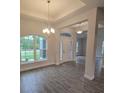 View of the home's entryway featuring decorative lighting and large windows at 14146 Baracoa Ln, Port Charlotte, FL 33981