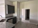 Kitchen with dark cabinets, granite countertops, stainless steel sink, and open layout at 14154 Baracoa Ln, Port Charlotte, FL 33981