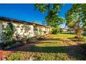 Landscaped side yard with brick walkway at 2220 Cannolot Blvd, Port Charlotte, FL 33948