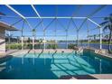 Screened-in pool with water view; a perfect outdoor oasis at 24282 Silver Ln, Punta Gorda, FL 33955