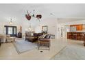 Spacious living room with a leather sectional sofa and hardwood floors at 2813 Sancho Panza Ct, Punta Gorda, FL 33950
