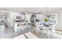Modern kitchen with white cabinets, island, and stainless steel appliances at 5131 Schubert Trl, North Port, FL 34287