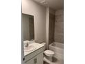 Bright bathroom showcasing a tub, tile surround, toilet and single sink vanity at 9531 Turtle Grass Cir, Punta Gorda, FL 33950