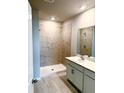 Bathroom features a glass door shower with tile surround and a single sink vanity at 9531 Turtle Grass Cir, Punta Gorda, FL 33950