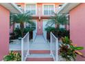 Ground level entrance with landscaped walkway and white railings at 2002 Bal Harbor Boulevard # 811, Punta Gorda, FL 33950