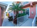Side entrance with stairs, landscaping, and a white railing at 2002 Bal Harbor Boulevard # 811, Punta Gorda, FL 33950