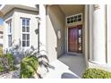 House entrance with a dark wooden door and columns at 24368 Westgate Blvd, Punta Gorda, FL 33980