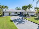 House exterior featuring a metal roof and palm trees at 3014 Guadalupe Dr, Punta Gorda, FL 33950