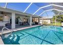 Inviting swimming pool with a screened enclosure and patio furniture at 3014 Guadalupe Dr, Punta Gorda, FL 33950