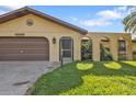 Single-story house with attached garage and palm trees at 1228 Lyle St, Port Charlotte, FL 33952