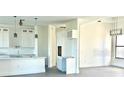 Open concept kitchen with white cabinets and breakfast bar at 16380 Cape Horn Blvd, Punta Gorda, FL 33955