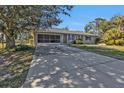 Single-story home with a screened garage and driveway at 18514 Goodman Cir, Port Charlotte, FL 33948