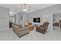 Spacious living room featuring neutral colors, comfy seating, and a large TV at 24415 Buckingham Way, Punta Gorda, FL 33980