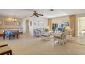 Bright living room with wicker furniture and view to the pool area at 2501 Rio Largo Ct, Punta Gorda, FL 33950