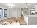 Spacious dining area with large window and wood-look floors at 7359 Van Lake Dr, Englewood, FL 34224