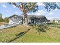 Charming single-story home with a mature tree in the front yard providing plenty of shade at 7359 Van Lake Dr, Englewood, FL 34224