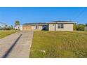 Single-story home with a stone facade and spacious yard at 130 Arlington Ne Ct, Port Charlotte, FL 33952