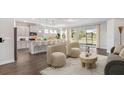 Open-concept living area with a kitchen island and backyard views at 16114 Highgate St, Port Charlotte, FL 33953