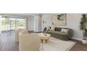 Well-decorated living room with contemporary furniture and sliding glass doors to lanai at 16114 Highgate St, Port Charlotte, FL 33953