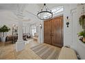Bright entryway with double doors and a chandelier at 17080 Kellog Ave, Port Charlotte, FL 33954