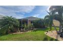 Backyard oasis with pond and tropical landscaping at 1787 Scarlett Ave, North Port, FL 34289