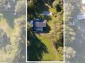 Aerial view of a quaint home surrounded by mature trees and lush greenery at 5344 Swaying Palm Dr, Punta Gorda, FL 33982