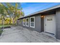 Home exterior featuring a private entrance, a well-maintained concrete area, and backyard at 5344 Swaying Palm Dr, Punta Gorda, FL 33982