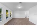 Bright living room with hardwood floors, plenty of natural light, and white walls at 5344 Swaying Palm Dr, Punta Gorda, FL 33982