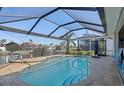 Inviting screened-in pool with ample deck space overlooking the canal at 566 Port Bendres Dr, Punta Gorda, FL 33950