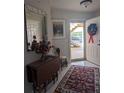 Bright entry with decorative mirror and drop-leaf table at 5800 Sabal Trace Dr # 507, North Port, FL 34287