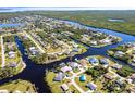 An aerial view showcasing the property's waterfront location and surrounding neighborhood at 18614 Kerrville Cir, Port Charlotte, FL 33948