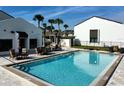Community pool with surrounding patio furniture and landscaping at 2000 Forrest Nelson Blvd # C8, Port Charlotte, FL 33952