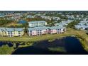 Aerial view highlighting condo building near lake and other buildings at 2120 Heron Lake Dr # 107, Punta Gorda, FL 33983