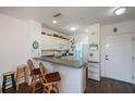 Condo kitchen with breakfast bar and white cabinets at 2160 Heron Lake Dr # 104, Port Charlotte, FL 33983