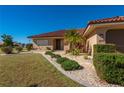 Landscaped front yard with walkway leading to a charming house entrance at 2935 Magdalina Dr, Punta Gorda, FL 33950